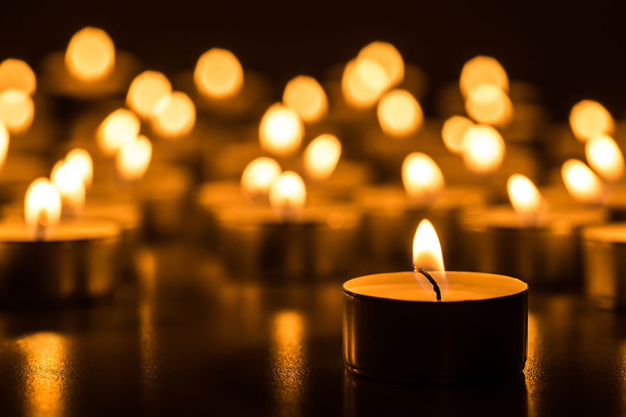 Christmas candles burning at night. Abstract candles background.